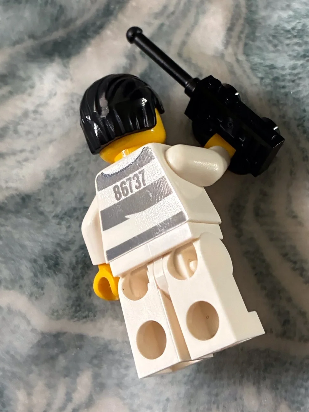 Lego Yellow Minifigure with Black Hair and White/Gray Striped Prison Outfit